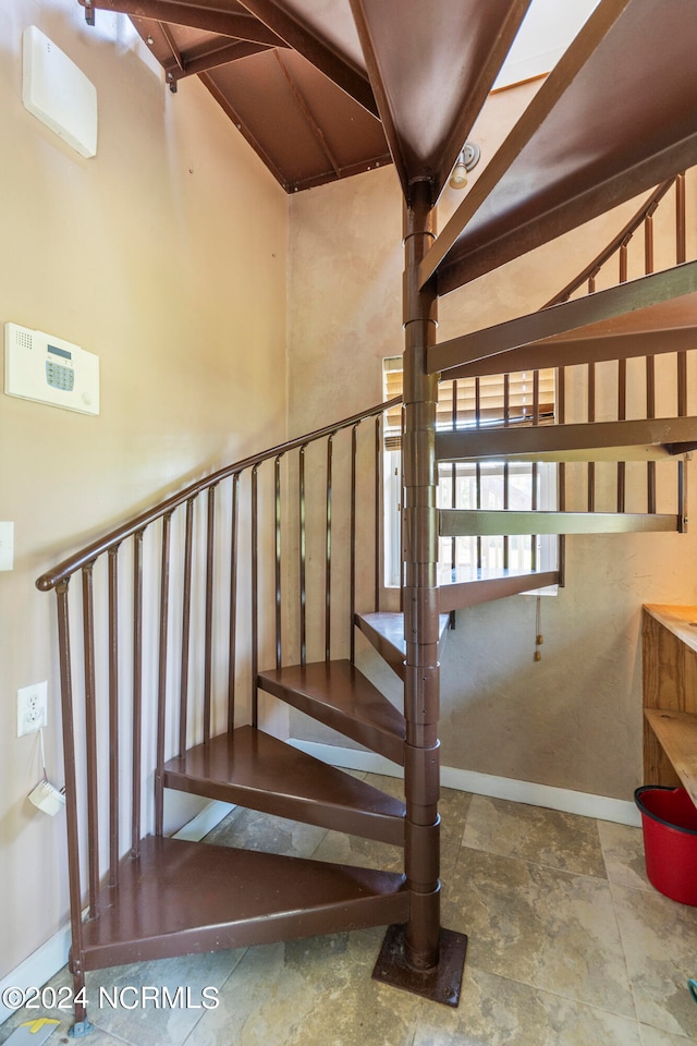 stairs featuring lofted ceiling