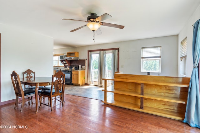 dining area with ceiling fan and light hardwood / wood-style floors