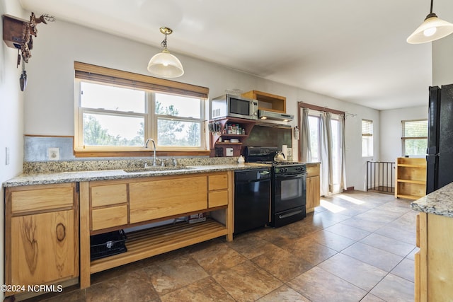 kitchen featuring decorative light fixtures, a sink, under cabinet range hood, and black appliances