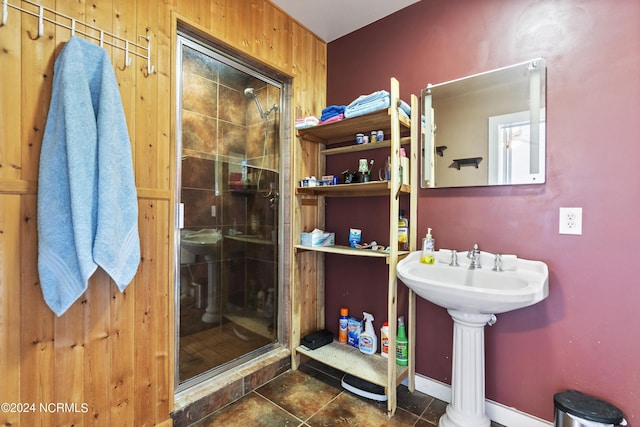 full bath with a stall shower, tile patterned flooring, and a sink