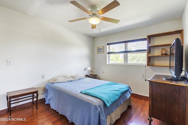 bedroom featuring baseboards and dark wood-type flooring