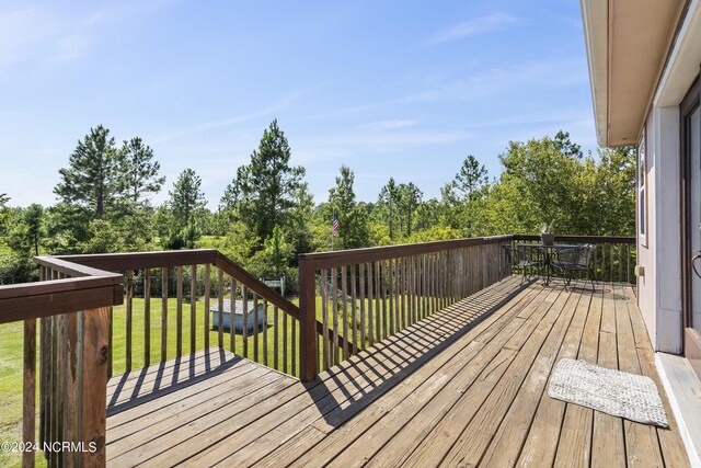 wooden terrace with a yard