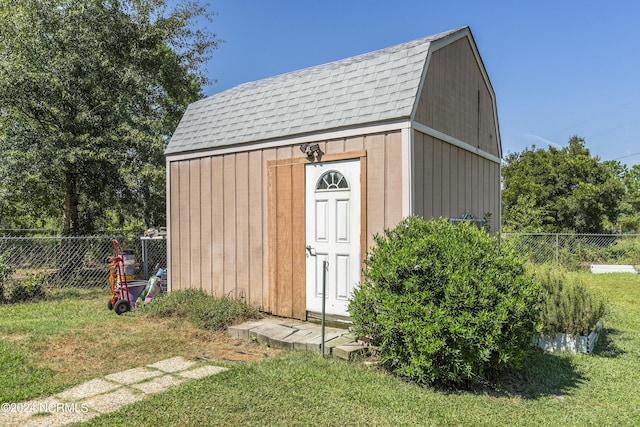 view of shed featuring fence