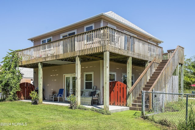 back of house with a deck, fence, stairway, a lawn, and a patio area