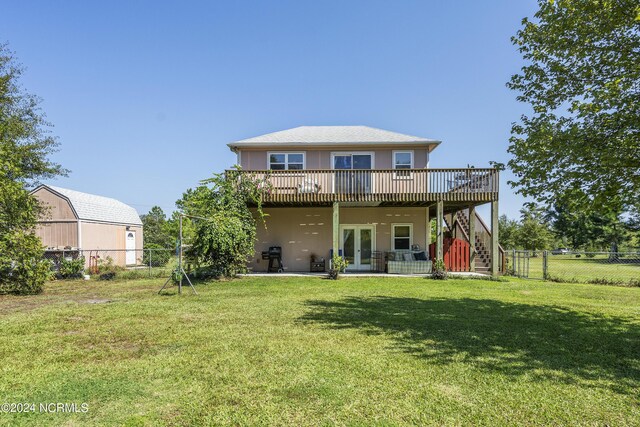 back of house featuring a yard, a patio, a wooden deck, and french doors