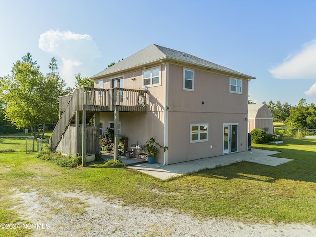 back of property featuring a yard, a patio, a wooden deck, and stairs