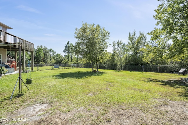 view of yard with a deck and fence