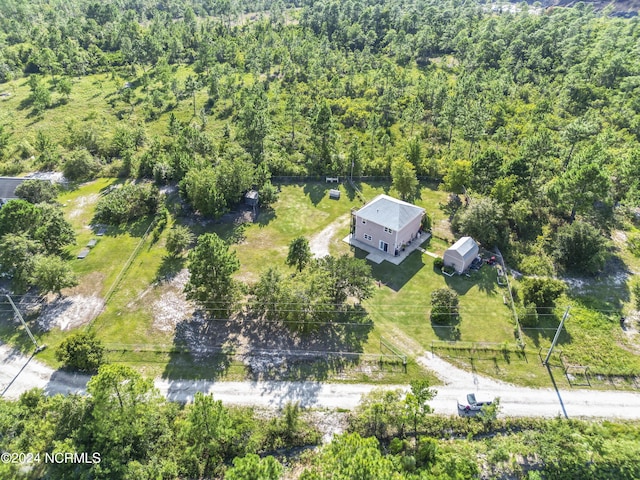 bird's eye view with a wooded view