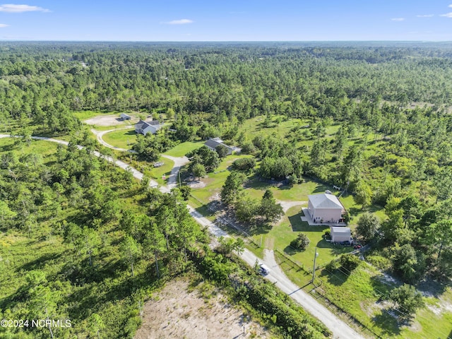 bird's eye view featuring a wooded view