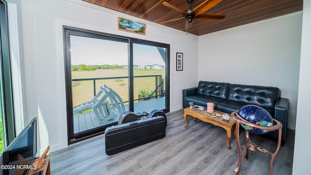 living room with ceiling fan, wooden ceiling, hardwood / wood-style floors, and crown molding