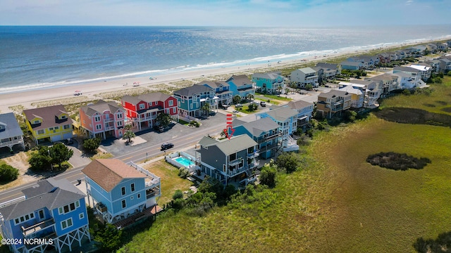 drone / aerial view featuring a beach view and a water view