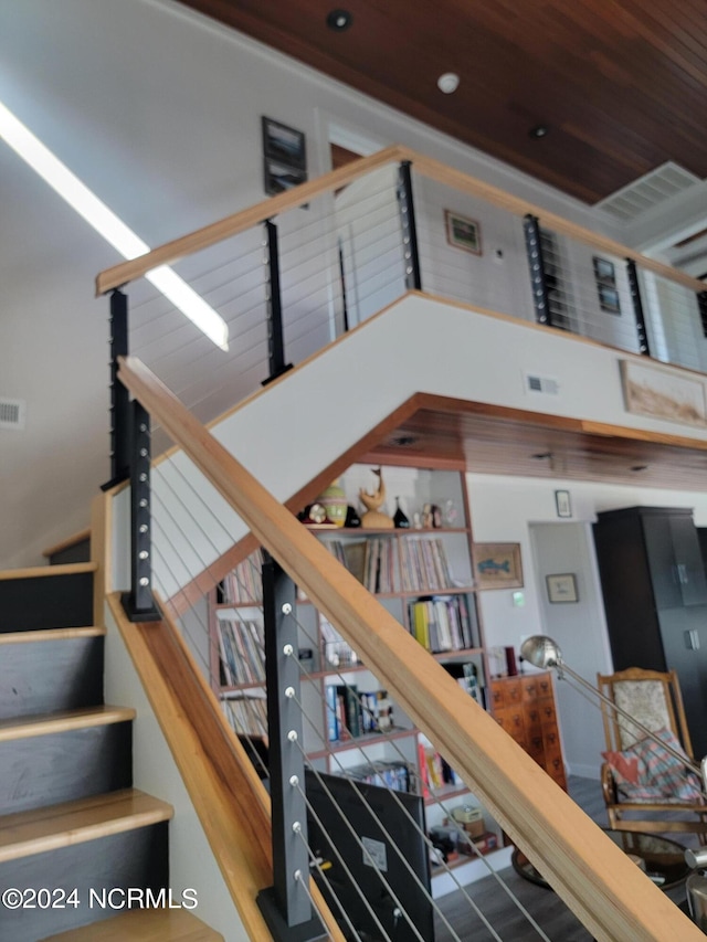 stairway with wooden ceiling