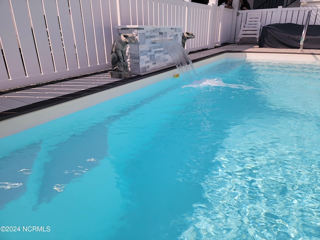 view of pool featuring pool water feature