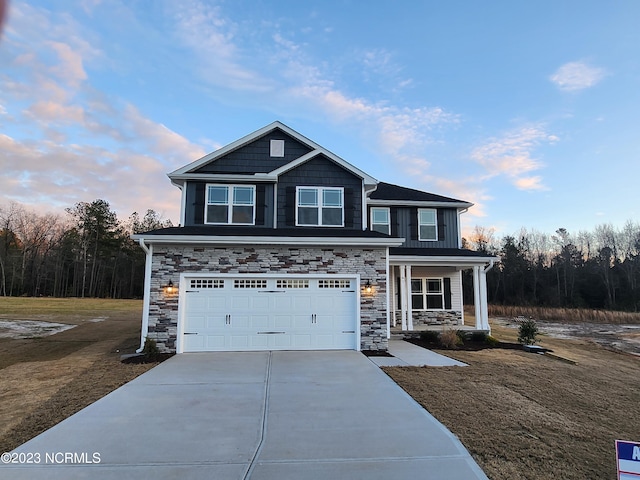 view of front of property featuring a garage and covered porch