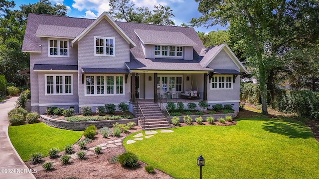 6404 Westport Dr, Wilmington, NC 28409 - view of front facade with stairway, covered porch, a front yard, and roof with shingles