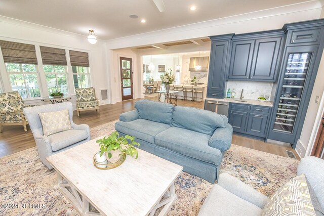 6404 Westport Dr, Wilmington, NC 28409 - living room with wet bar, light wood-style floors, recessed lighting, and ornamental molding