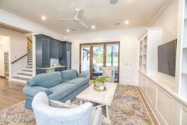 6404 Westport Dr, Wilmington, NC 28409 - living area with a ceiling fan, ornamental molding, stairway, light wood finished floors, and baseboards