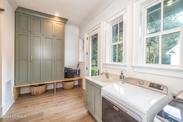 6404 Westport Dr, Wilmington, NC 28409 - washroom featuring cabinet space, independent washer and dryer, light wood-type flooring, and recessed lighting