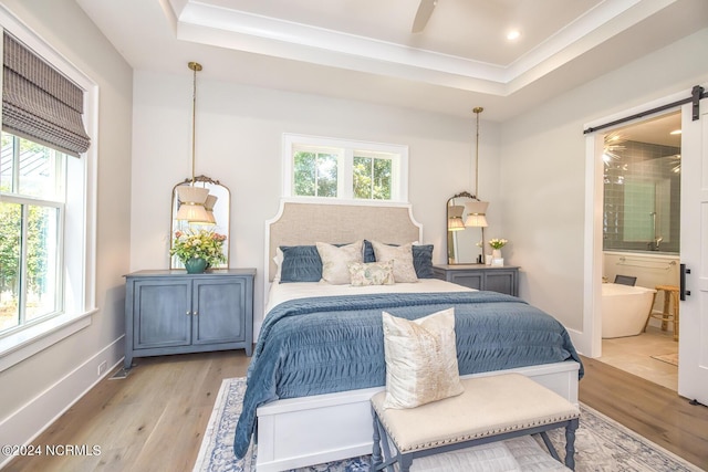6404 Westport Dr, Wilmington, NC 28409 - bedroom featuring multiple windows, light wood-type flooring, a raised ceiling, and recessed lighting