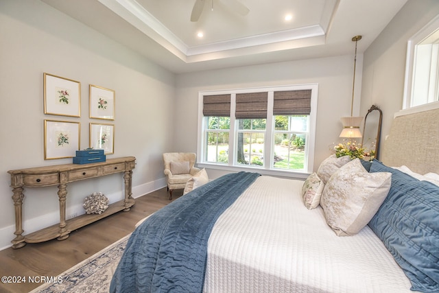 6404 Westport Dr, Wilmington, NC 28409 - bedroom featuring wood finished floors, a raised ceiling, baseboards, and ceiling fan