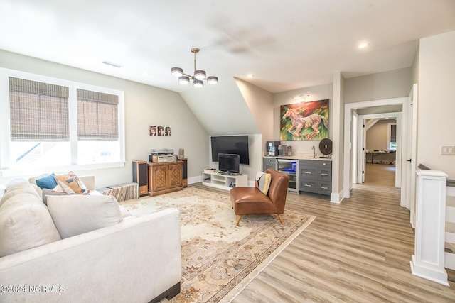 6404 Westport Dr, Wilmington, NC 28409 - living room featuring light wood finished floors, a chandelier, baseboards, bar area, and recessed lighting