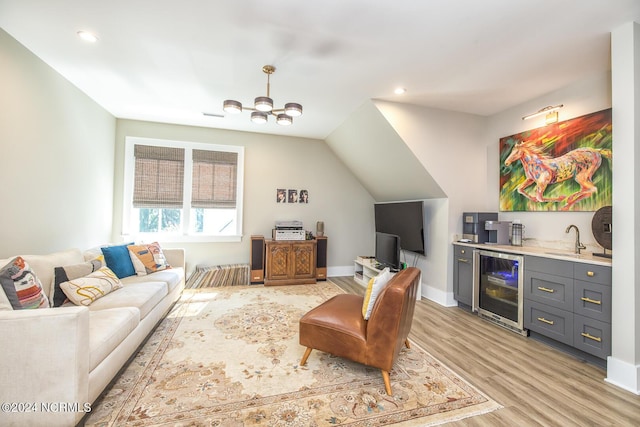 6404 Westport Dr, Wilmington, NC 28409 - living room featuring beverage cooler, light wood finished floors, wet bar, a chandelier, and recessed lighting