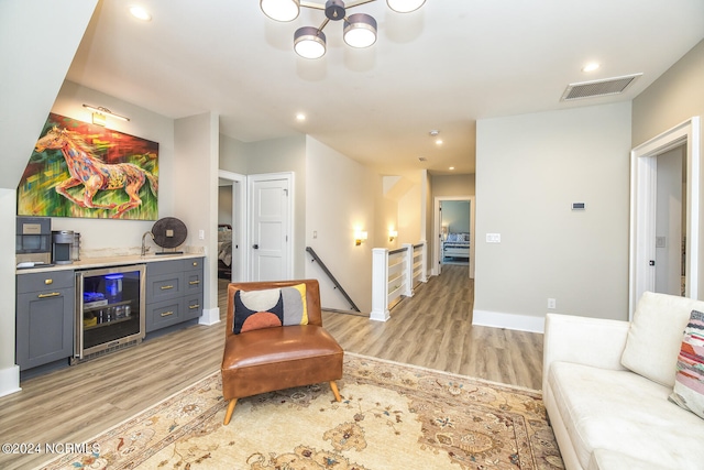 6404 Westport Dr, Wilmington, NC 28409 - living area featuring beverage cooler, light wood-type flooring, a dry bar, recessed lighting, and baseboards
