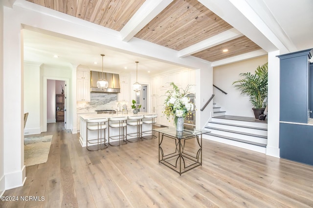 6404 Westport Dr, Wilmington, NC 28409 - living room with light wood-type flooring, recessed lighting, stairs, ornamental molding, and wood ceiling with exposed beams