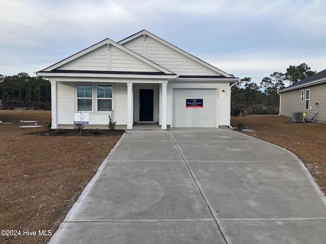 view of front of house with cooling unit and a garage