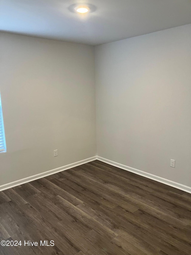 empty room with dark wood-type flooring