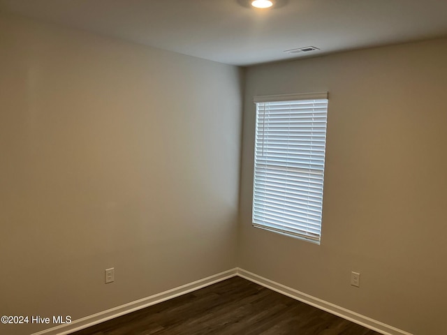 empty room featuring dark hardwood / wood-style flooring