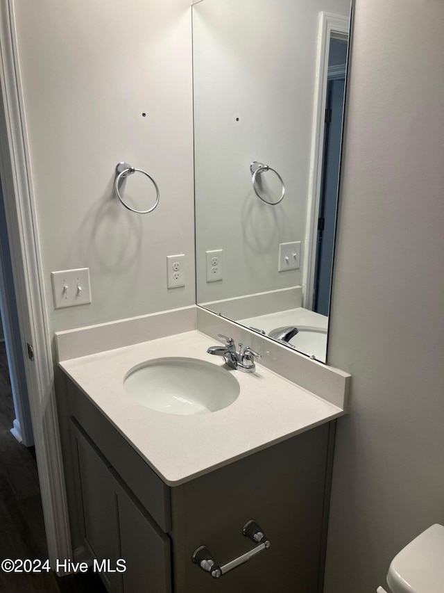 bathroom featuring vanity and toilet