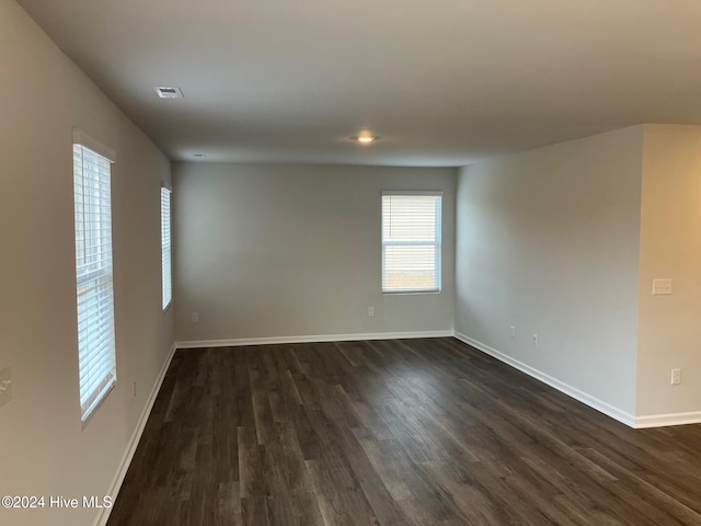 unfurnished room with dark hardwood / wood-style floors