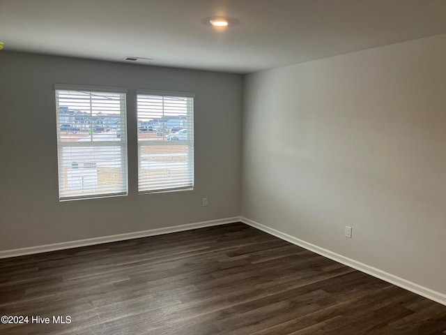 empty room featuring dark wood-type flooring