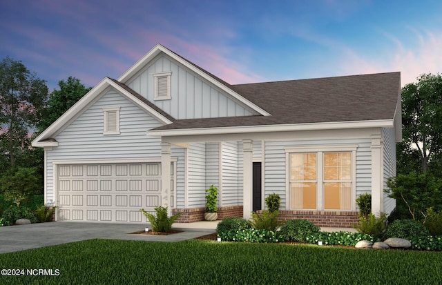 view of front of home with an attached garage, concrete driveway, board and batten siding, and brick siding