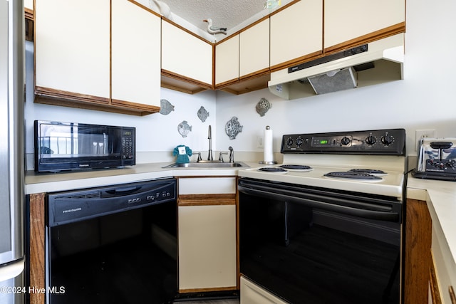 kitchen with under cabinet range hood, light countertops, black appliances, white cabinetry, and a sink