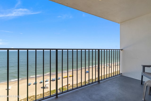 balcony featuring a water view and a beach view