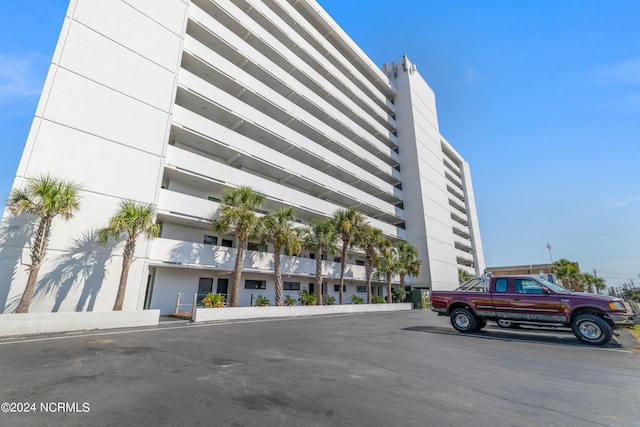 view of property featuring uncovered parking