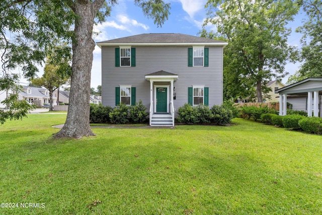 colonial inspired home with a front lawn