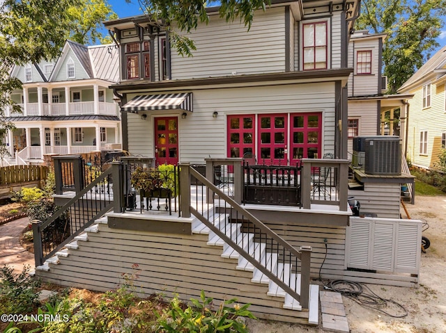 rear view of property with stairs and central air condition unit