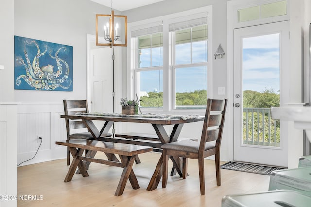 dining space featuring a notable chandelier and light hardwood / wood-style floors