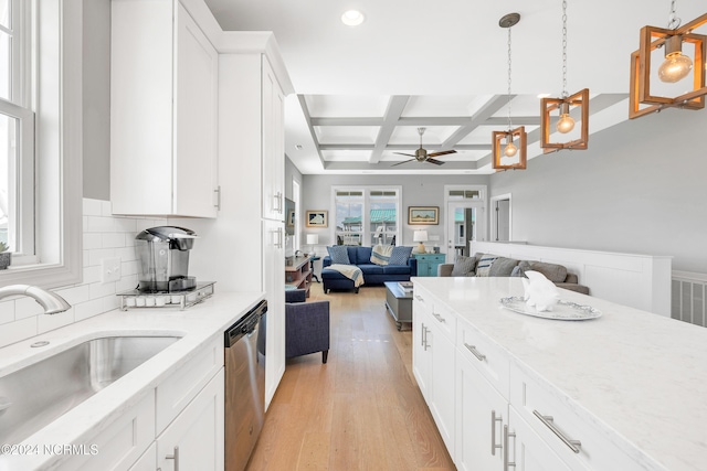 kitchen with coffered ceiling, hanging light fixtures, white cabinetry, and stainless steel dishwasher