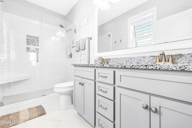 bathroom featuring tile patterned floors, a shower with shower door, vanity, and toilet