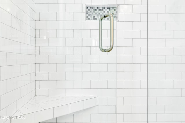 bathroom featuring a shower with shower door