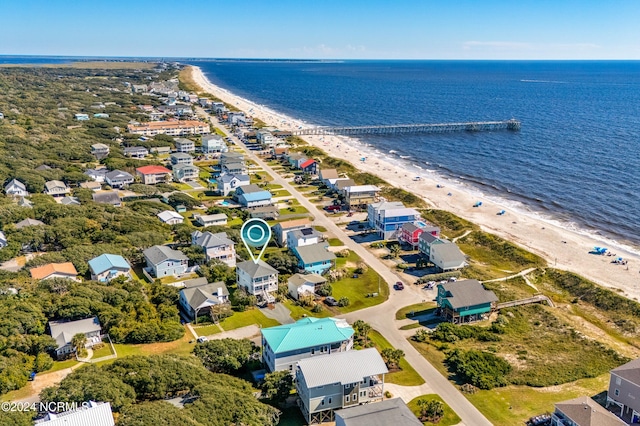 aerial view with a water view and a beach view