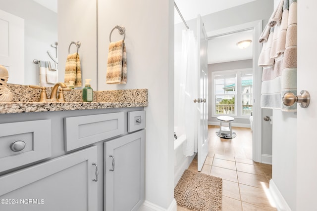 bathroom with shower / bath combination with curtain, vanity, and tile patterned flooring