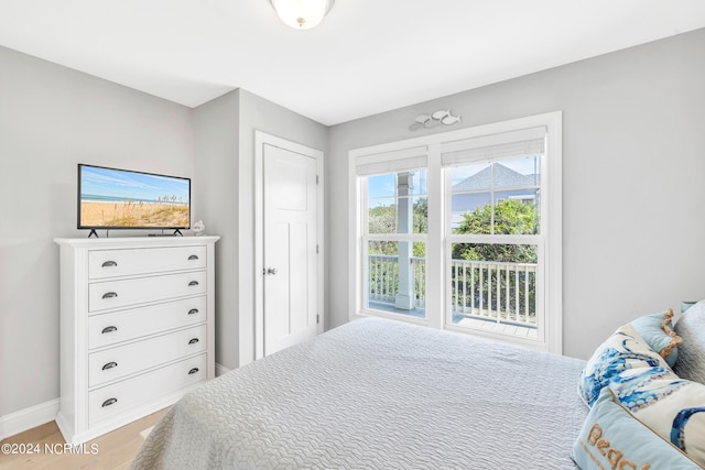 bedroom with access to outside and light hardwood / wood-style flooring