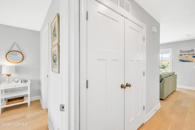 hallway with light hardwood / wood-style flooring