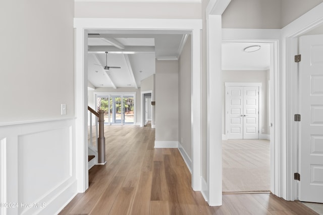 hall with wood-type flooring and lofted ceiling with beams