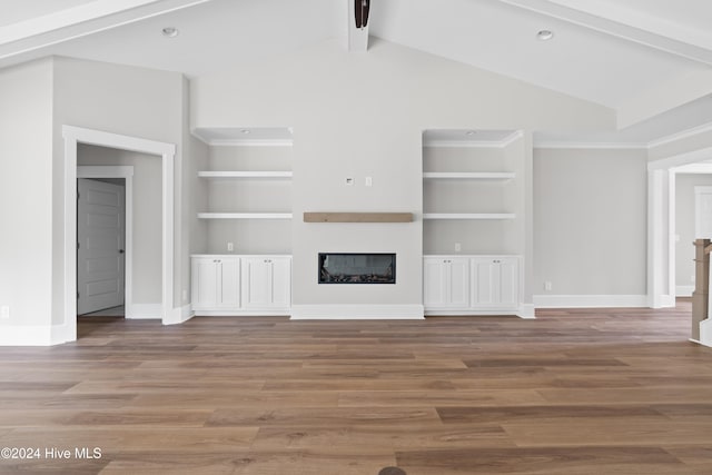 unfurnished living room featuring vaulted ceiling with beams, built in shelves, and wood-type flooring